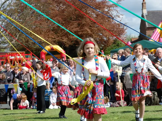 In this image there are a few people standing, in front of them, there are a few children's holding...