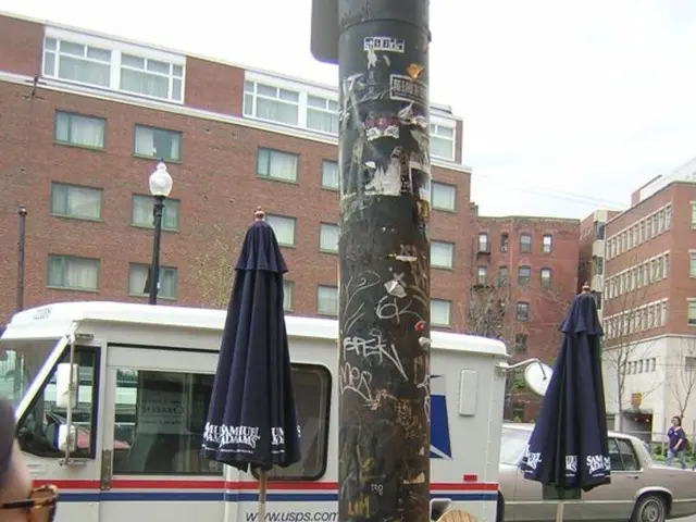In the image we can see there are table and chairs on the footpath and the cars and vans is parked...