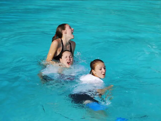 In this image we can see women in water.