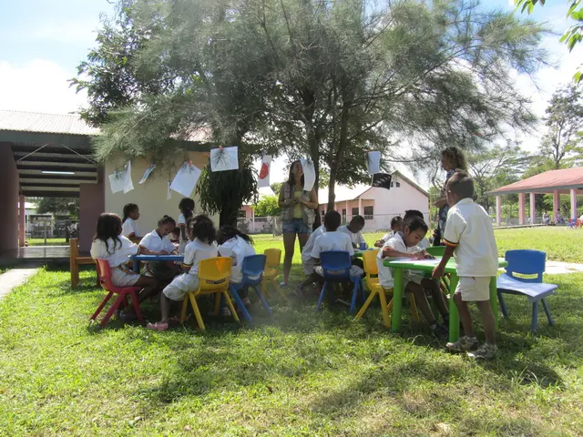 The image is taken in the garden. In the center of the image there is a lady standing before her...