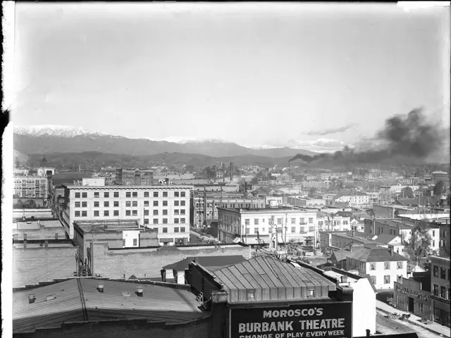 In the image we can see there are buildings and there is a factory. There is a smoke coming out of...