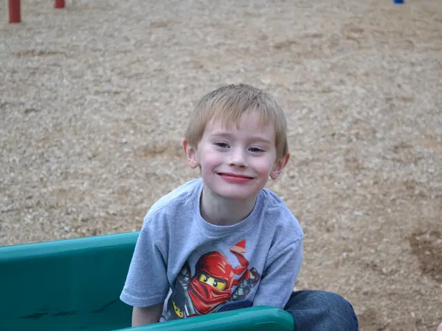 Here in this picture we can see a kid sitting on a bench over there and smiling and we can also see...